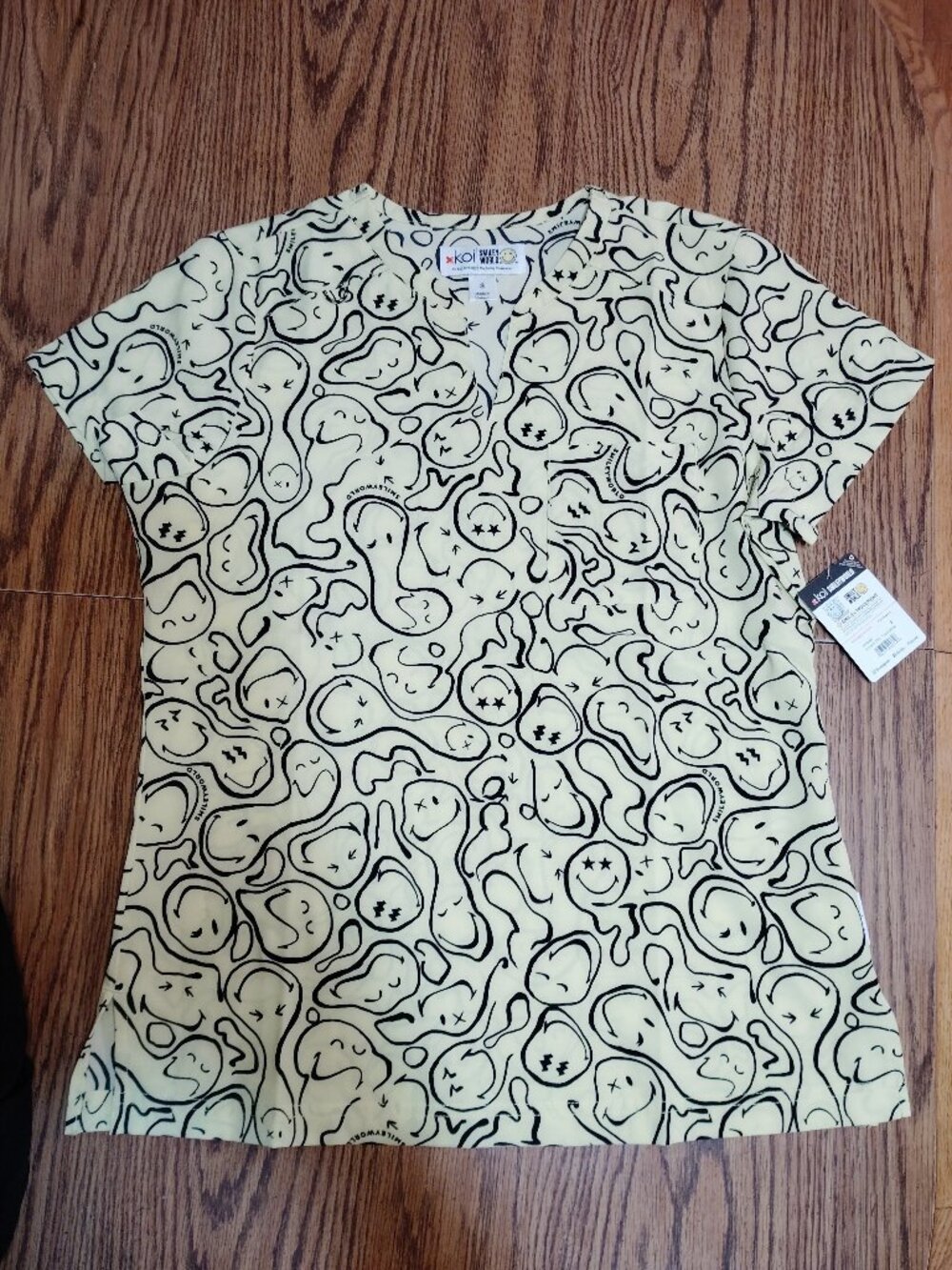 Trippy smiley face scrub top